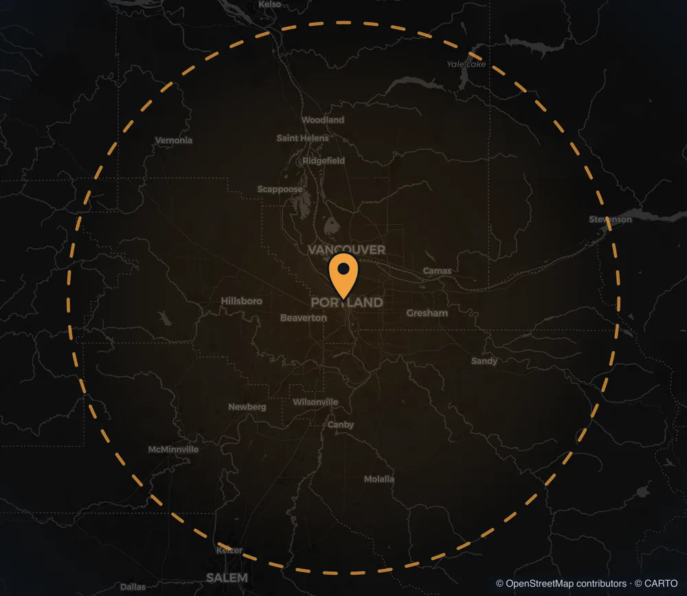 Map of the Portland metro at night with a pin on downtown and a wide service ring reaching past Vancouver, Hillsboro, and Sandy